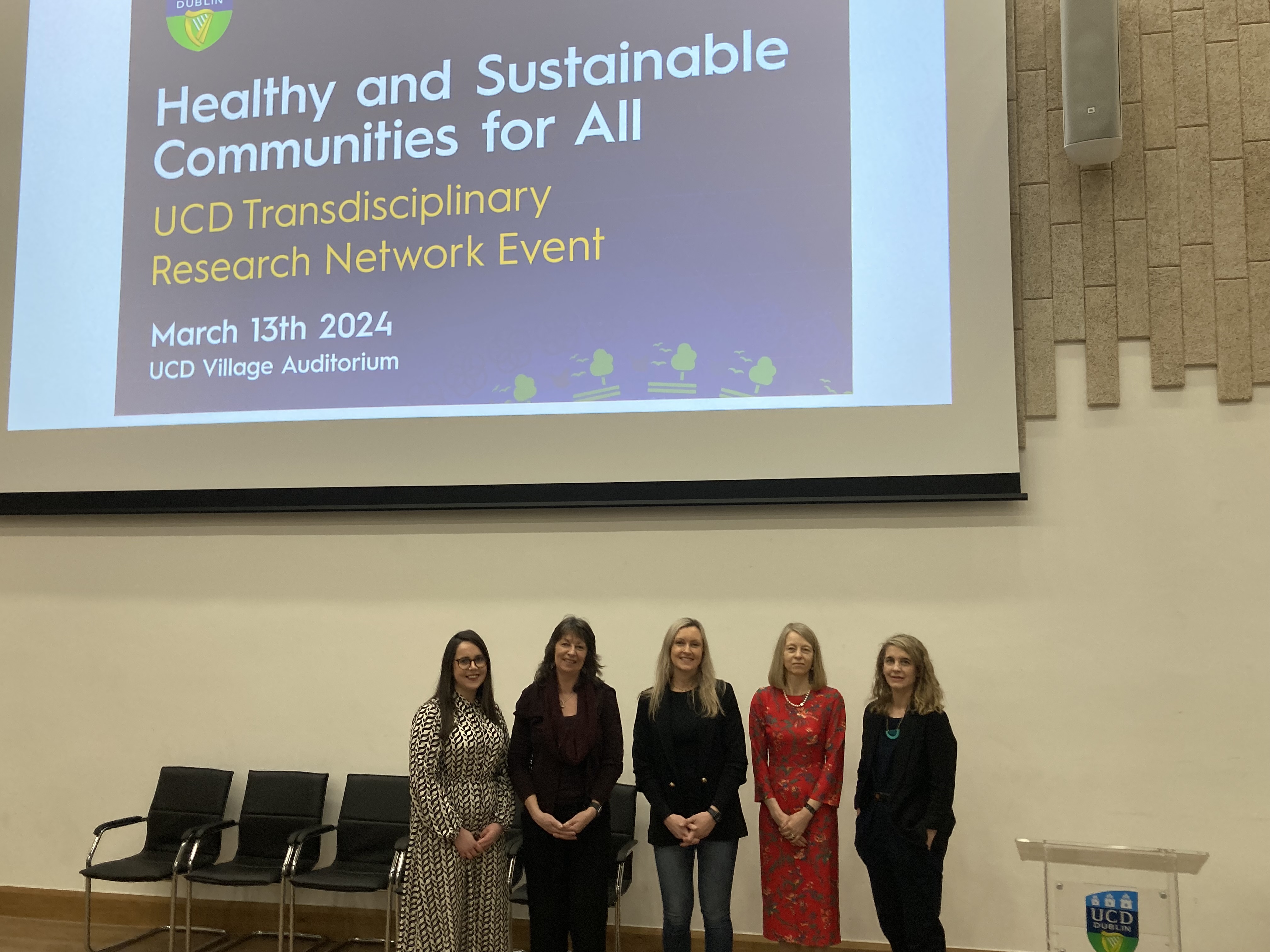 three female academics standing infront of screen